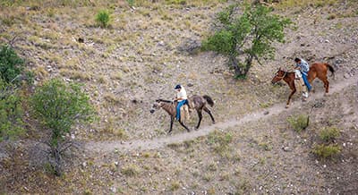 Riding on a trail along the border on horses